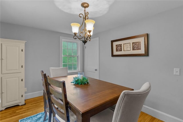 223 Chopmist Hill Rd, Glocester, RI 02814 - dining room featuring a chandelier, light wood-style floors, and baseboards