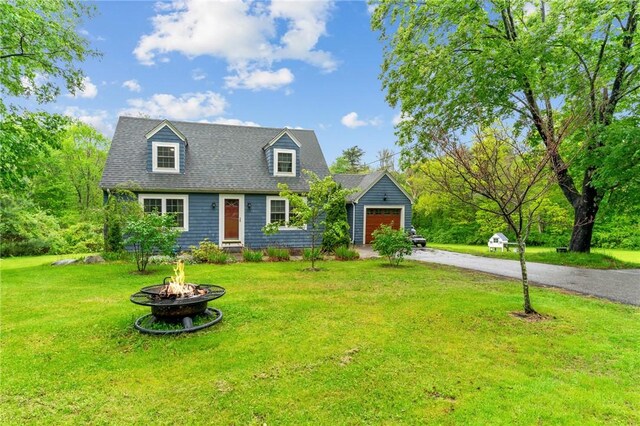 223 Chopmist Hill Rd, Glocester, RI 02814 - cape cod-style house featuring an attached garage, a fire pit, asphalt driveway, and a front yard