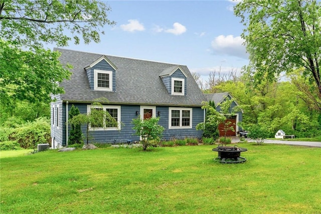 223 Chopmist Hill Rd, Glocester, RI 02814 - cape cod house featuring a fire pit, a front yard, and roof with shingles