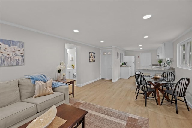 120 Aspinet Dr, Warwick, RI 02888 - living area with ornamental molding, light wood finished floors, recessed lighting, and baseboards