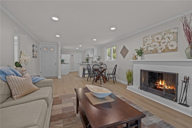 120 Aspinet Dr, Warwick, RI 02888 - living area with light wood-style flooring, crown molding, a fireplace, recessed lighting, and baseboards