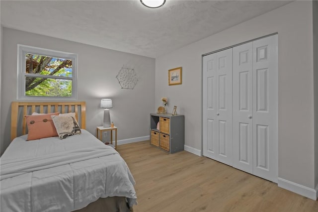 120 Aspinet Dr, Warwick, RI 02888 - bedroom featuring baseboards, wood finished floors, and a closet