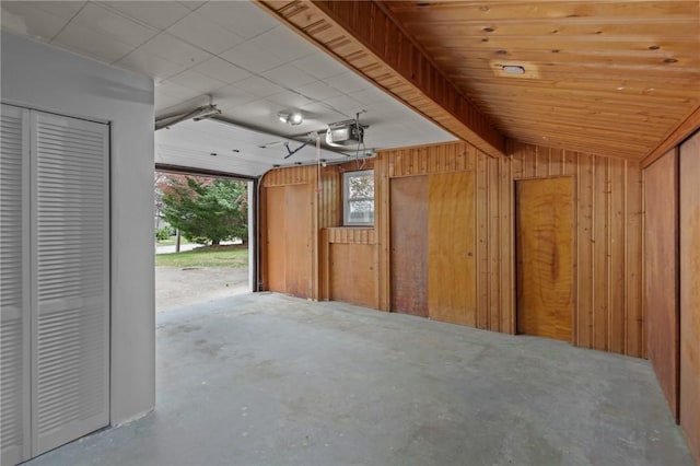 120 Aspinet Dr, Warwick, RI 02888 - garage featuring wood walls and a garage door opener