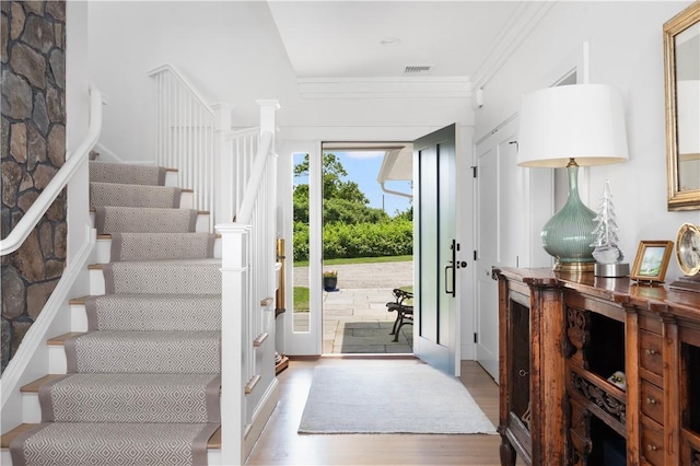 61 Baileys Ledge Rd, Little Compton, RI 02837 - entryway with wood finished floors, stairs, and crown molding