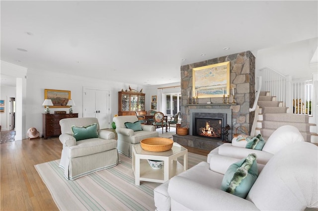 61 Baileys Ledge Rd, Little Compton, RI 02837 - living room featuring hardwood / wood-style flooring, a fireplace, and stairs