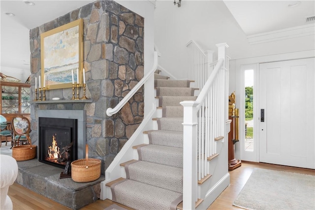 61 Baileys Ledge Rd, Little Compton, RI 02837 - entryway with wood finished floors, stairs, and a stone fireplace