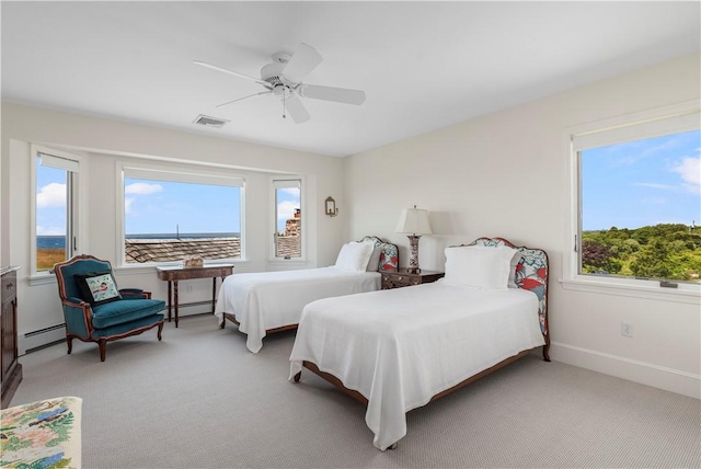 61 Baileys Ledge Rd, Little Compton, RI 02837 - bedroom featuring multiple windows, baseboard heating, light carpet, and a ceiling fan