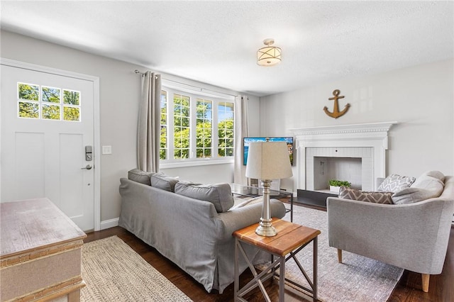 25 Old Pine Rd, Narragansett, RI 02882 - living room with dark wood finished floors, a fireplace, baseboards, and a textured ceiling