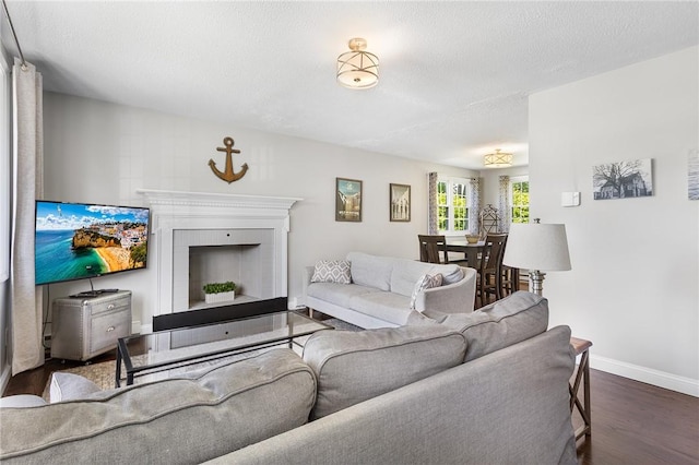 25 Old Pine Rd, Narragansett, RI 02882 - living room featuring wood finished floors, baseboards, a fireplace, and a textured ceiling