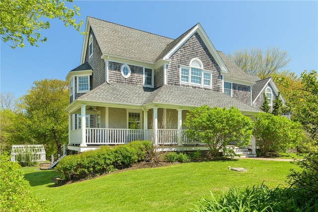 38 Westwind Dr, Jamestown, RI 02835 - shingle-style home with a shingled roof, covered porch, and a front lawn