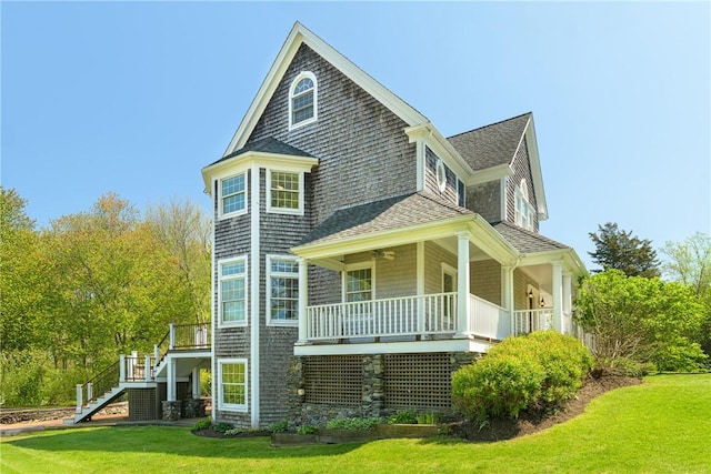 38 Westwind Dr, Jamestown, RI 02835 - view of front of house featuring stairs, roof with shingles, a front lawn, covered porch, and a ceiling fan