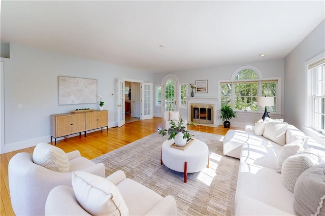 38 Westwind Dr, Jamestown, RI 02835 - living room with wood finished floors, baseboards, and a fireplace with flush hearth