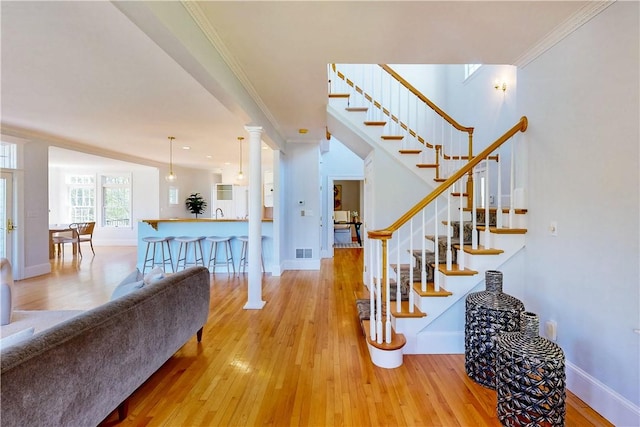 38 Westwind Dr, Jamestown, RI 02835 - stairway featuring wood-type flooring, crown molding, and baseboards