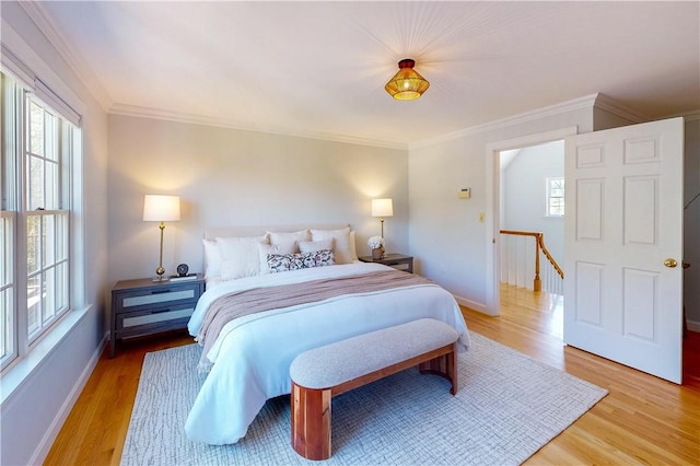 38 Westwind Dr, Jamestown, RI 02835 - bedroom with ornamental molding, multiple windows, light wood finished floors, and baseboards