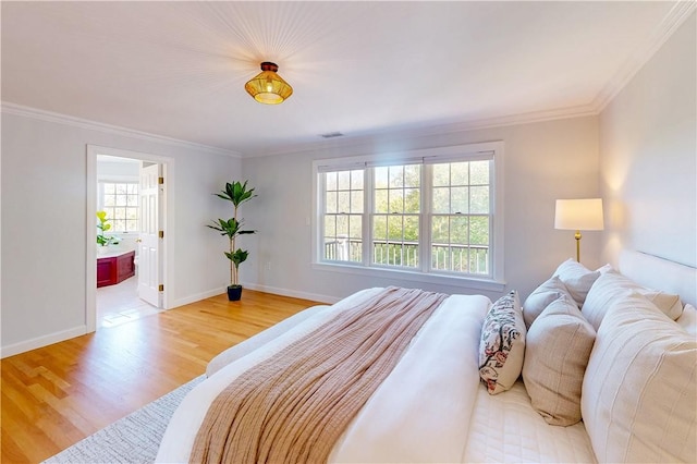 38 Westwind Dr, Jamestown, RI 02835 - bedroom with light wood-type flooring, ornamental molding, baseboards, and ensuite bath