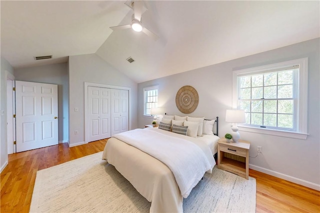 38 Westwind Dr, Jamestown, RI 02835 - bedroom with light wood finished floors, a closet, baseboards, vaulted ceiling, and a ceiling fan