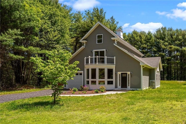 888 Plainfield Pike, Coventry, RI 02827 - rear view of property featuring a balcony, gravel driveway, a yard, and a garage