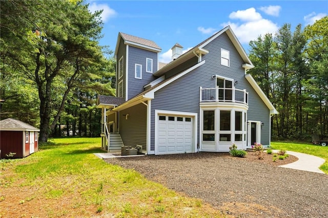 888 Plainfield Pike, Coventry, RI 02827 - view of front facade with a balcony, gravel driveway, an attached garage, and a front yard