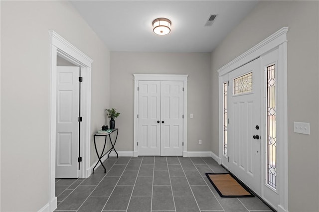 888 Plainfield Pike, Coventry, RI 02827 - foyer entrance featuring dark tile patterned flooring and baseboards