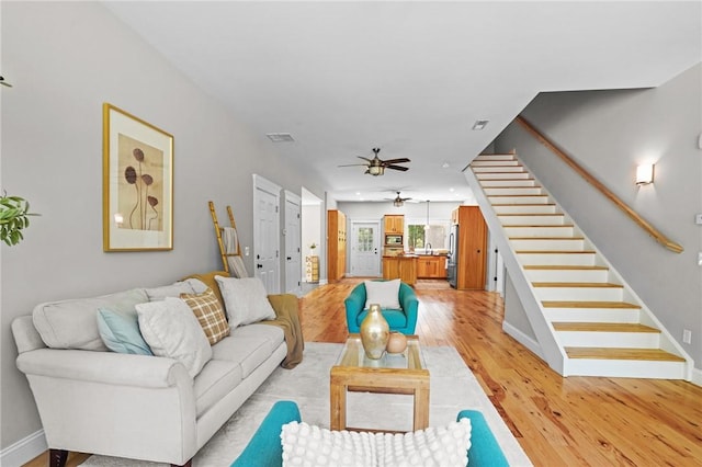 888 Plainfield Pike, Coventry, RI 02827 - living room with stairs, light wood-style floors, and baseboards