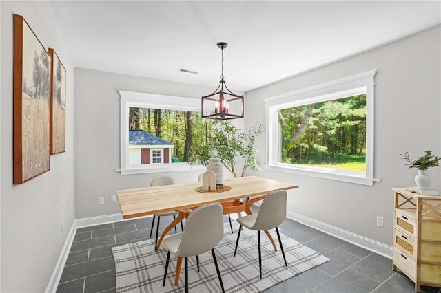 888 Plainfield Pike, Coventry, RI 02827 - dining room with dark tile patterned floors, baseboards, and a chandelier