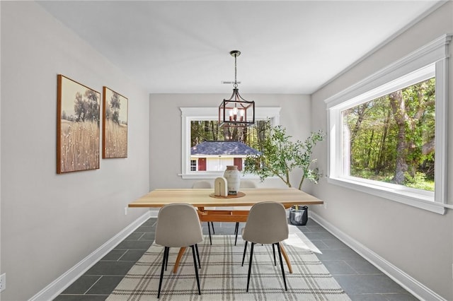 888 Plainfield Pike, Coventry, RI 02827 - dining space with dark tile patterned floors, a chandelier, and baseboards