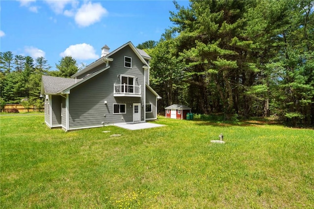 888 Plainfield Pike, Coventry, RI 02827 - rear view of house featuring a balcony, a chimney, a patio, and a lawn