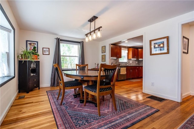 45 Nichols Rd, North Kingstown, RI 02852 - dining space with light wood finished floors and baseboards
