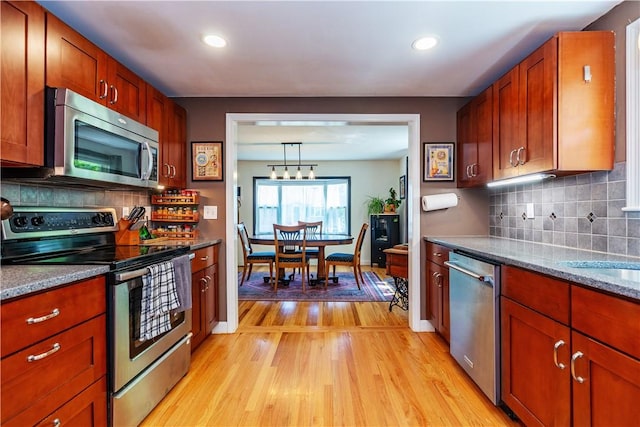 45 Nichols Rd, North Kingstown, RI 02852 - kitchen with appliances with stainless steel finishes, light wood finished floors, tasteful backsplash, recessed lighting, and stone countertops