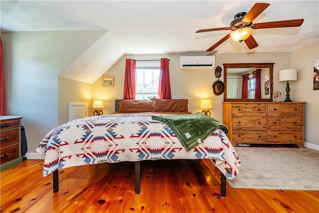 45 Nichols Rd, North Kingstown, RI 02852 - bedroom with an AC wall unit, wood finished floors, baseboards, and ceiling fan