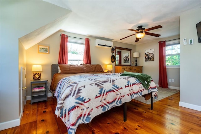 45 Nichols Rd, North Kingstown, RI 02852 - bedroom with an AC wall unit, wood-type flooring, baseboards, and ceiling fan