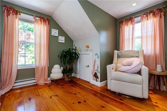 45 Nichols Rd, North Kingstown, RI 02852 - living area with baseboards, a baseboard radiator, plenty of natural light, wood-type flooring, and vaulted ceiling
