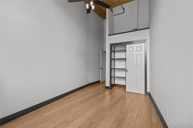 521 S Main St Unit 308, Providence, RI 02903 - unfurnished bedroom with a towering ceiling, baseboards, light wood-style floors, and a ceiling fan