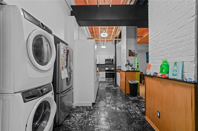 1117 Douglas Ave Unit 120, North Providence, RI 02904 - laundry room with stacked washer / drying machine and dark marble finish flooring