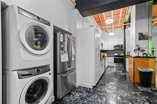 1117 Douglas Ave Unit 120, North Providence, RI 02904 - laundry room featuring stacked washer and clothes dryer and dark marble finish flooring