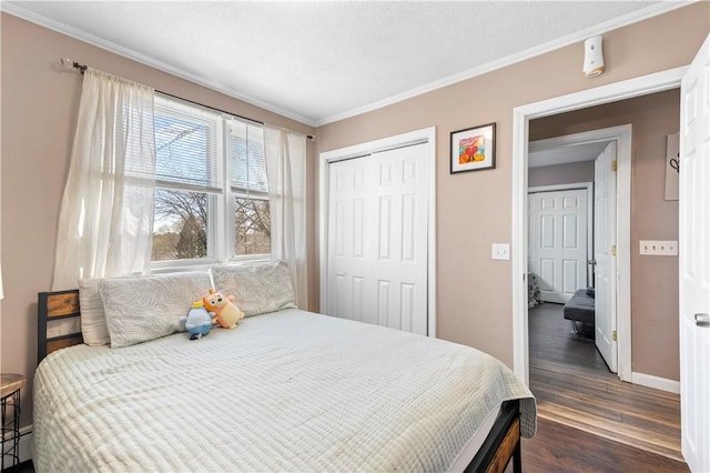 37 Boundary Ave, Providence, RI 02909 - bedroom with crown molding, baseboards, dark wood-style floors, a closet, and a baseboard radiator