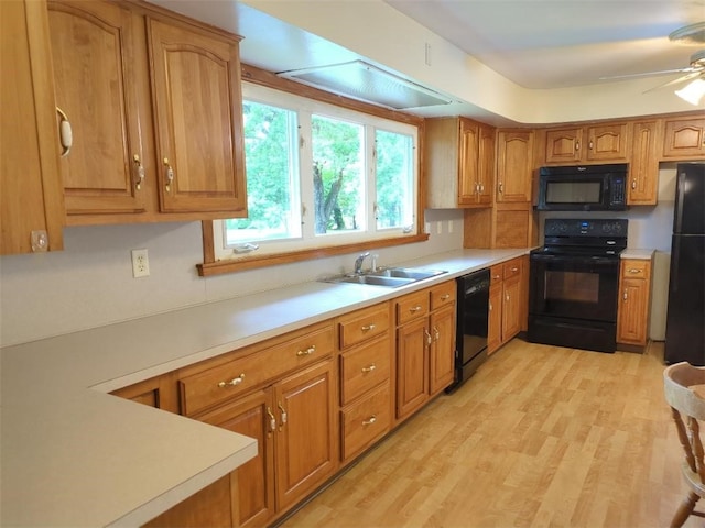 13 Ivy Pl, Lincoln, RI 02865 - kitchen with black appliances, a sink, light countertops, brown cabinets, and light wood-style flooring