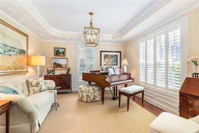 83 Preservation Way S, Kingstown, RI 02879 - living area featuring a chandelier, a tray ceiling, wainscoting, ornamental molding, and wood finished floors