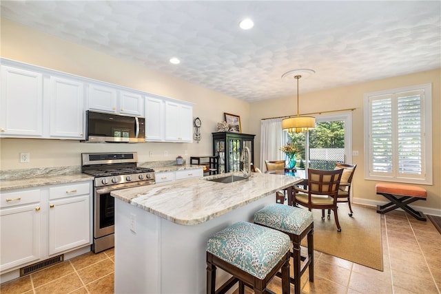 83 Preservation Way S, Kingstown, RI 02879 - kitchen featuring stainless steel appliances, a sink, white cabinetry, a kitchen breakfast bar, and recessed lighting