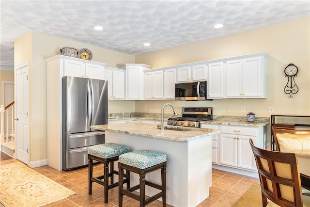 83 Preservation Way S, Kingstown, RI 02879 - kitchen with appliances with stainless steel finishes, a sink, white cabinetry, light tile patterned floors, and recessed lighting