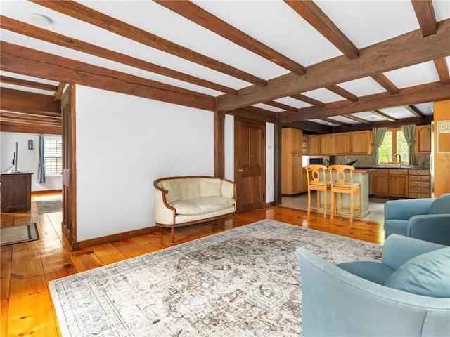 12 Rustic Acres Dr, Glocester, RI 02814 - living area featuring beam ceiling, light wood-style floors, and baseboards