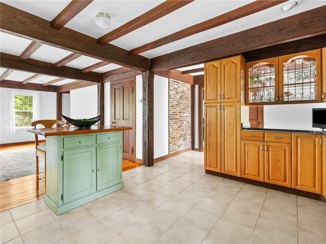 12 Rustic Acres Dr, Glocester, RI 02814 - kitchen featuring beam ceiling, baseboards, a kitchen breakfast bar, and a kitchen island
