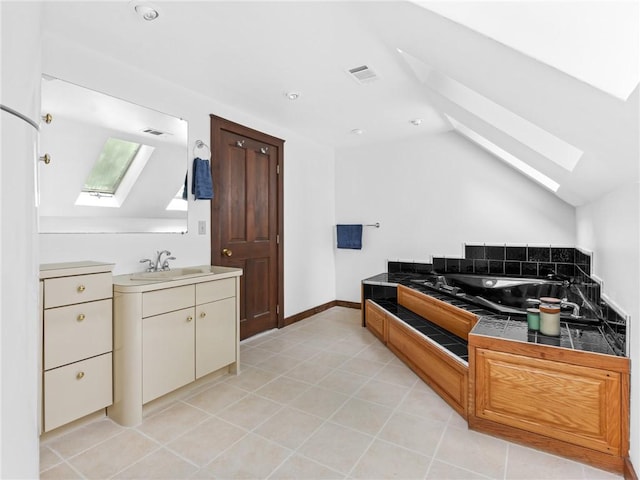 12 Rustic Acres Dr, Glocester, RI 02814 - bathroom with a skylight, lofted ceiling, a garden tub, vanity, and tile patterned floors