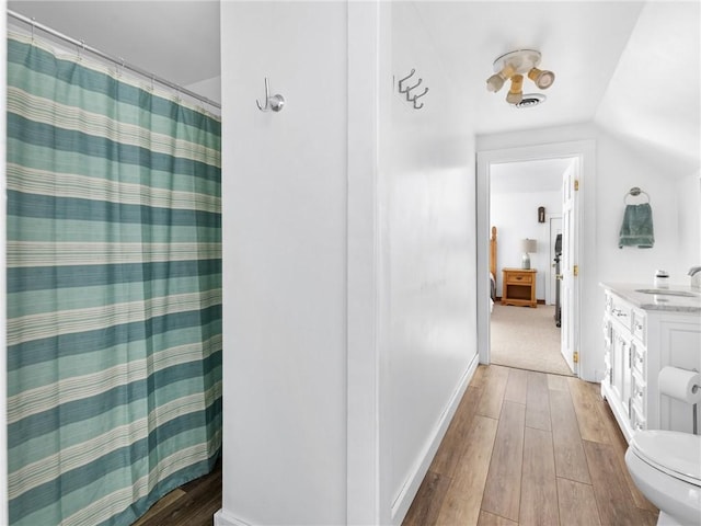 12 Rustic Acres Dr, Glocester, RI 02814 - bathroom featuring hardwood / wood-style floors, toilet, vanity, lofted ceiling, and a shower with curtain