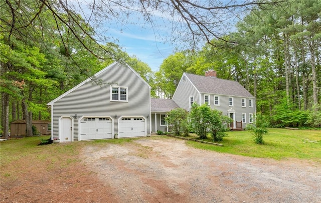 12 Rustic Acres Dr, Glocester, RI 02814 - colonial house featuring dirt driveway, a garage, a chimney, a front lawn, and roof with shingles