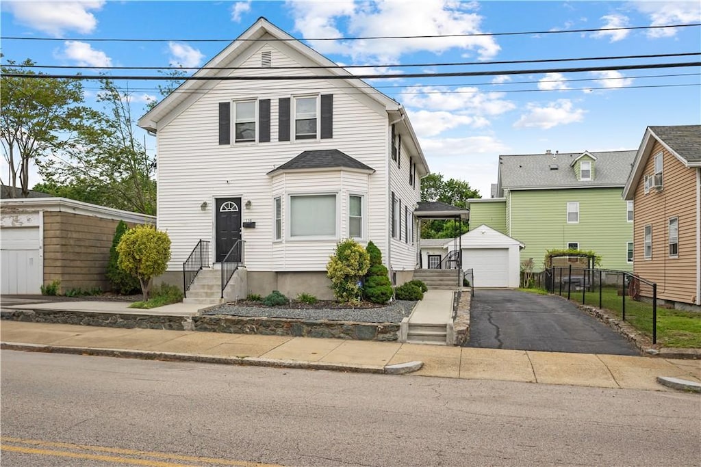 116 Pond St, Pawtucket, RI 02860 - traditional-style house featuring entry steps, an outdoor structure, a detached garage, driveway, and cooling unit