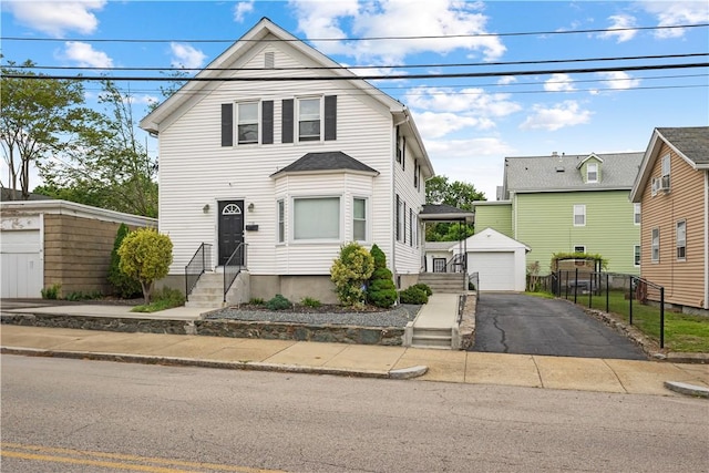 116 Pond St, Pawtucket, RI 02860 - traditional-style house featuring entry steps, an outdoor structure, a detached garage, driveway, and cooling unit