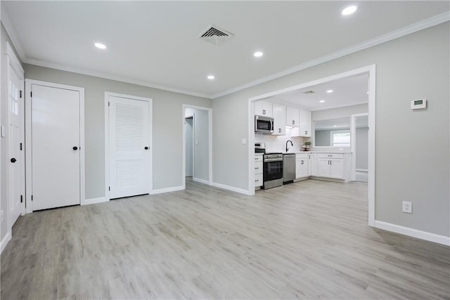 31 Forbes St, East Providence, RI 02915 - unfurnished living room featuring light wood finished floors, baseboards, ornamental molding, a sink, and recessed lighting