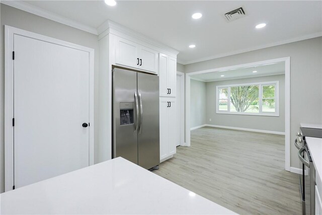 31 Forbes St, East Providence, RI 02915 - kitchen featuring stainless steel fridge with ice dispenser, crown molding, stove, baseboards, and white cabinets