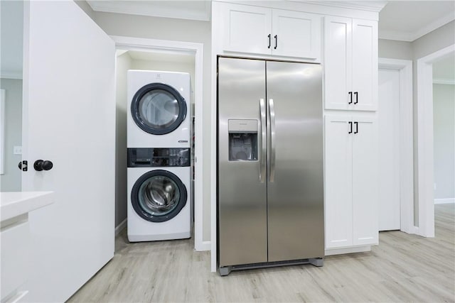 31 Forbes St, East Providence, RI 02915 - washroom with stacked washer and clothes dryer, ornamental molding, light wood-type flooring, and baseboards